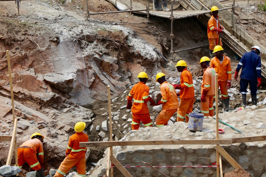 Workers on a dam construction site